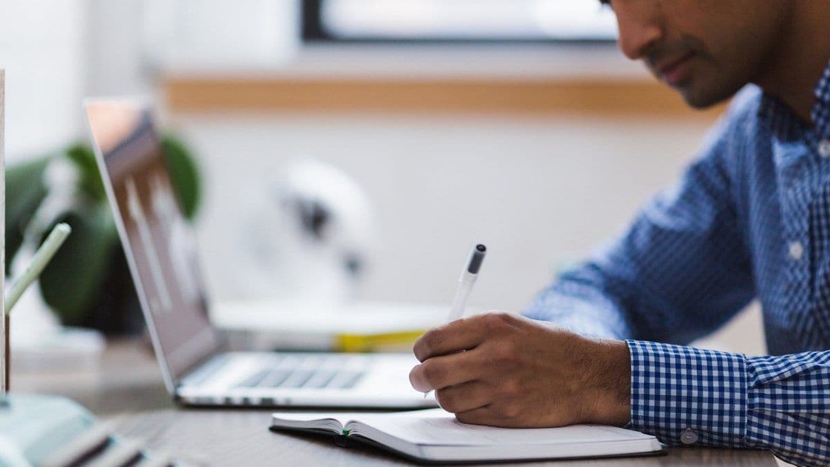 man writing - JetBrains AI Assistant vs Copilot