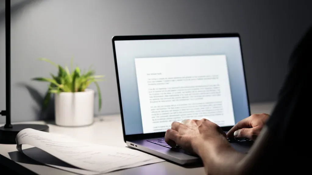man typing - Best AI for Essay Writing Tools